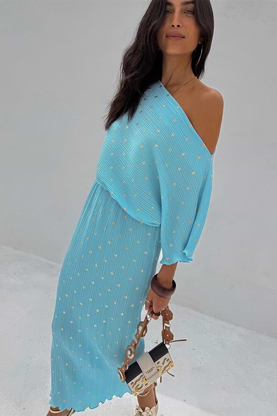 Turquoise Tilly Dress in light blue plisse with gold flecks, styled off-the-shoulder for a multi-wear look.