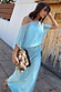 Blue Chiffon Tilly Dress with an off-the-shoulder bodice and satin skirt, styled with a beaded clutch.