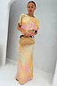 Pink Boho Elodie Dress in a pastel ombre print with gold flecks, styled with a woven straw clutch.