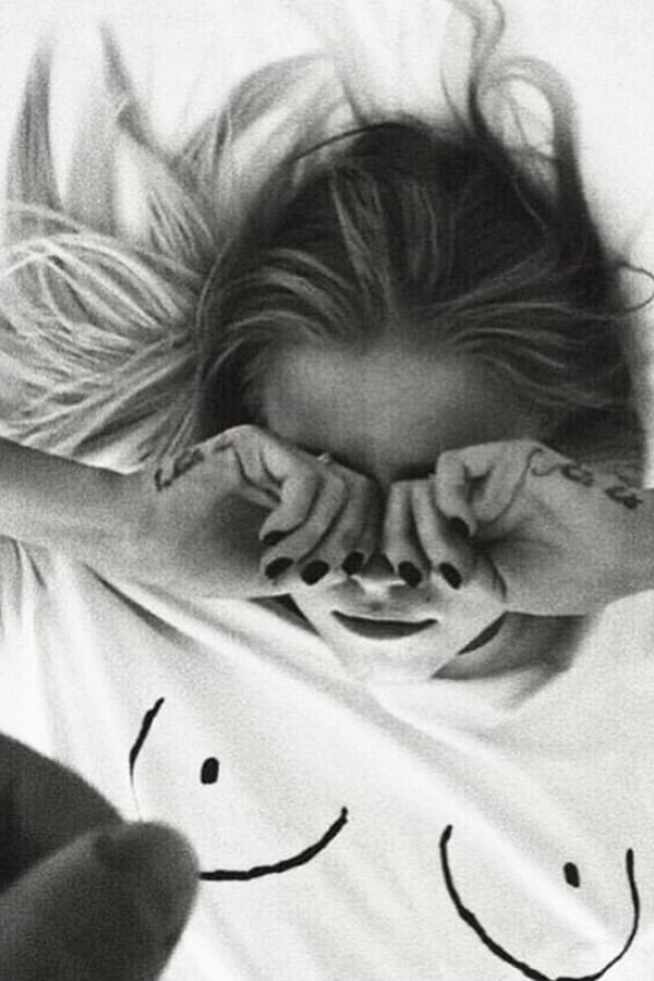 Iconic white Boob T-shirt with line drawing detail on a model lying down in black and white.