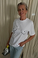 Iconic white Boob T-shirt with a black line graphic, paired with blue jeans and a silver bag.