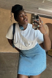 White Boob T-shirt with black line art, styled with a blue denim skirt in a mirror selfie.