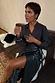 Thumbnail for Bottle green vegan leather Ruffle Jaspre wrap skirt, styled with a dark shirt and statement gold jewellery.
