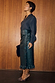 Thumbnail for Bottle Green Vegan Leather Ruffle Jaspre Skirt with side frill detailing, styled with a navy blouse and leopard heels.