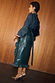 Thumbnail for Bottle Green Vegan Leather Ruffle Jaspre Skirt with a wrap tie and frill hem, styled with leopard print heels.