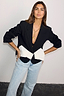 Black Bow Crop Blazer with a large white bow detail and button fastening, styled with light-wash jeans.