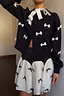 Thumbnail for Black Bow Sophie Cardigan in a heavy knit with contrast cream 3D bows and a tie-neck fastening.