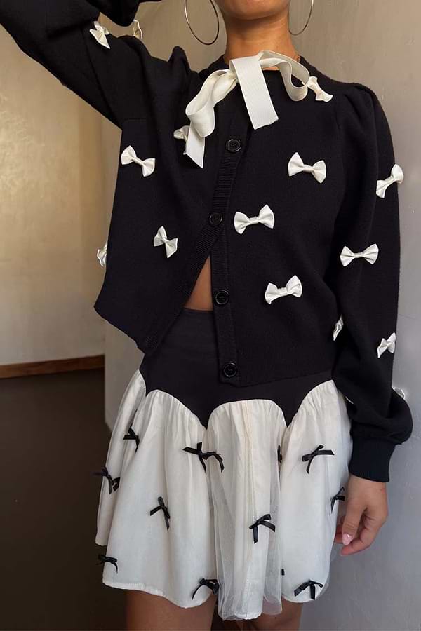 Black Bow Sophie Cardigan in a heavy knit with contrast cream 3D bows and a tie-neck fastening.