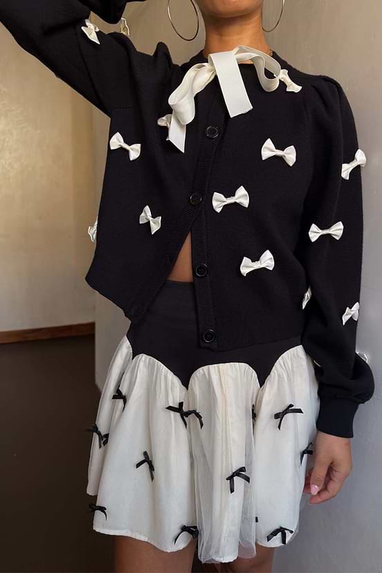 Black Bow Sophie Cardigan in a heavy knit with contrast cream 3D bows and a tie-neck fastening.