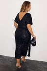 Black Sequin Bow Dress with a V-back and velvet tie detail, showcasing inclusive sizing in a midi length.