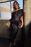 Thumbnail for Black Sequin Bow Dress with an asymmetric neckline and velvet waist tie, styled with a clutch for a party look.
