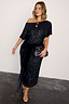 Thumbnail for Black Sequin Bow Dress in a shimmering midi length with a velvet waist tie, styled with a patterned clutch bag.