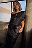 Black Sequin Bow Midi Dress styled off-the-shoulder with a velvet multi-wear tie, shown on a model with a clutch.