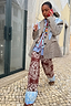 Thumbnail for Chocolate Bandana Wide Leg knit trousers with a blue hem, paired with a check blazer on a cobblestone street.