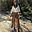 Brown Bandana Cassie Skirt featuring a white paisley print and ruffled high-low hem, styled for a desert festival look.