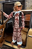 Thumbnail for Kids Chocolate Bandana Knitted Set in a brown paisley print and blue contrast, styled with a black vest in a car doorway.