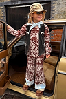 Kids Chocolate Bandana Knitted Set in a brown paisley print and blue contrast, styled with a black vest in a car doorway.