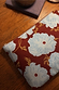 Blue and Burgundy Poppy Laptop Case featuring an in-house designed floral print and gold zip on a wooden table.