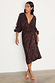 Chocolate Sequin Vienna Dress with a multi-wear wrap waist and long sleeves, styled with gold strappy sandals.