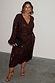 Chocolate Sequin Vienna Dress with a wrap waist and long sleeves on a model in UK size 18.