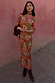 Olive Buckles Mesh Midaxi Dress with western motifs and long sleeves, styled with brown boots and a scarf.