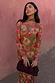 Olive Buckles Mesh Dress featuring western horseshoe motifs and long sleeves, styled with a neck scarf and clutch.