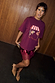 Thumbnail for Burgundy Fruit Shop T-Shirt with a relaxed fit and graphic print, paired with a sequined lace mini skirt.