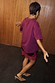 Thumbnail for Burgundy Fruit Shop T-Shirt in a relaxed fit with dropped shoulders, styled with a lace mini skirt and tan heels.