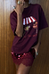 Thumbnail for Burgundy Fruit Shop T-shirt with a relaxed fit and dropped shoulders, styled with a red sequinned lace skirt.