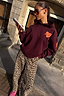 Thumbnail for Burgundy cotton-blend hoodie with coral orange embroidery and leopard print trousers for a London look.