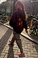 Thumbnail for Burgundy graphic hoodie paired with iconic Leopard Barrel Jeans for a street style look by a canal.