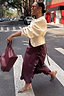 Thumbnail for Burgundy Vegan Leather Ruffle Jaspre Skirt with side ruffles and leopard print heels on a city crossing.