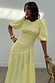 Thumbnail for Butter Yellow Shirred Nara Dress with puff sleeves and a pleated skirt, styled in a London studio.