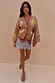 Camel Mystical Cardigan with celestial embroidery and red trim worn over a patterned blue lace dress.