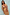 Thumbnail for Model wears Camel Mystical Cardigan with gold sun and moon embroidery and red ribbed trim.