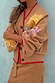 Camel Mystical Cardigan with sun embroidery, red trim and button-up front, styled with a tan skirt.