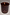 Thumbnail for NFD Eau De Parfum Candle 001 in a burgundy glass jar with a lit wick and gold script logo.
