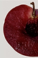 Deep red sliced plum with a dark stone, highlighting a key fragrance note for the NFD Candle 001.