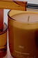 NFD Scent 002 amber glass candle with signature branding and notes of pink pepper and creamy vanilla.