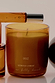 NFD Scent 002 Candle in an amber glass jar with gold lettering, paired with the matching perfume bottle.