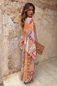 Dolce Vita Cape Top in a colourful tile patchwork print with wide fluid sleeves, styled with matching trousers.