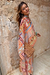 Dolce Vita Cape Top in a pastel tile patchwork print with wide fluid sleeves and a detachable matching scarf.