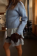 Ice Blue Studded Cardigan featuring silver metal sleeve studs and structured darts, paired with a lace-trimmed skirt.