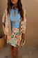 Dreamer Astrid Cardigan with colourful sun and star motifs, paired with a matching beaded mini skirt.