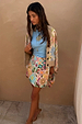 Cream Dreamer Astrid Cardigan with sun and star motifs in a soft knit, layered over a colourful beaded skirt.