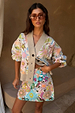 White Dreamer Astrid Cardigan with sun, star and palm motifs, styled with a matching beaded skirt and sunglasses.