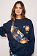 Navy Charm Bumbag with colourful hand-painted motifs, worn cross-body over a matching navy sweatshirt.