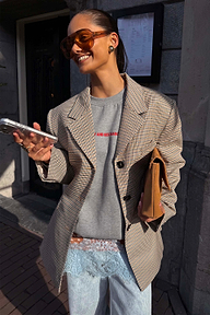 Grey Check Blazer featuring tailored darts, styled over a sweatshirt for a transeasonal London look.