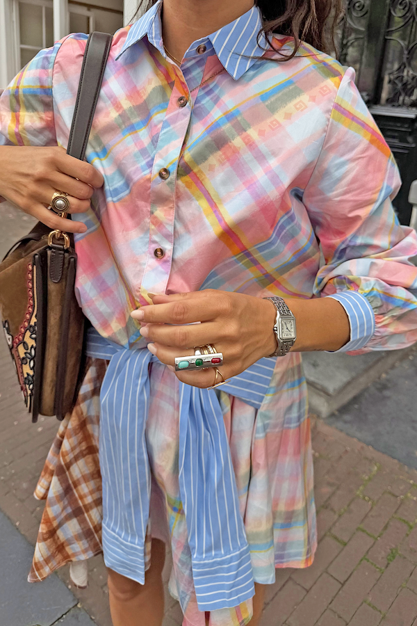 Pastel check shirt featuring a detachable blue striped pussy bow tied at the waist for a multi-wear London look.