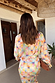 Check Sun Geanie Shirt and Jaspre Skirt featuring a colourful checkered print with sun motifs, seen from behind.